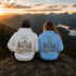 Vintage outdoor graphic hoodie featuring a small left chest design and a large mountain landscape graphic on the back, available in multiple colors and shown in various lifestyle and product mockups.