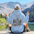 Vintage outdoor graphic hoodie featuring a small left chest design and a large mountain landscape graphic on the back, available in multiple colors and shown in various lifestyle and product mockups.