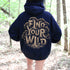 Featuring the bold phrase "Find Your Wild" crafted in a unique tree branch letter font, this hoodie is a celebration of the untamed beauty of the forest and the freedom it inspires.