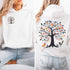 This hoodie features a delightful folk art design of vibrant birds perched in a tree adorned with colorful leaves and blooming flowers, creating a scene that radiates joy and creativity.