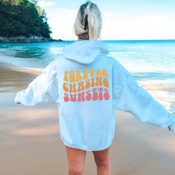 Introducing our stylish "Forever Chasing Sunsets" beach hoodie, the perfect companion for your seaside adventures!