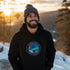 This unique hoodie features a mesmerizing graphic of the aurora borealis dancing across the night sky, with a majestic wolf howling at the moon, creating a sense of mystery and wonder.