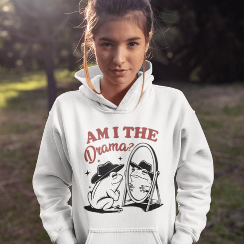Yeehaw, drama lovers! Meet your new favorite hoodie: a fabulous frog in a cowboy hat, staring into a mirror and asking the ultimate question, "Am I the drama?"