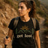 Woman hiking wearing a black get lost t-shirt with mountain and sun graphic
