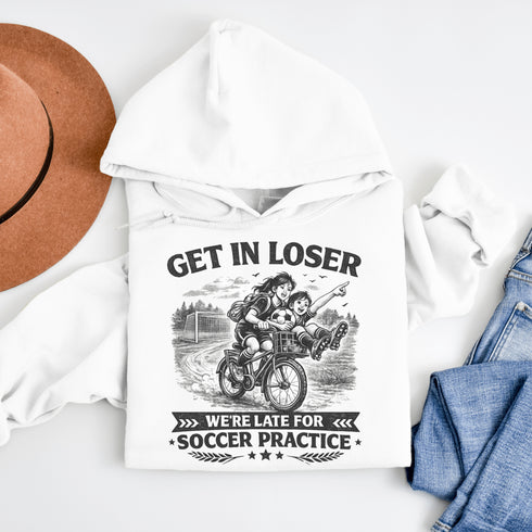 Funny soccer hoodie design showing two kids riding a bike to soccer practice with the phrase get in loser we’re late for soccer practice