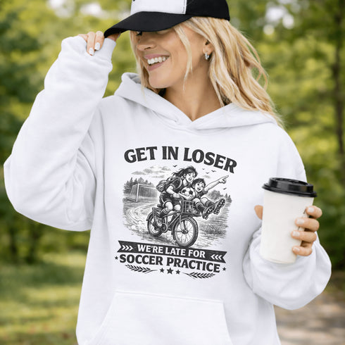 Funny soccer hoodie design showing two kids riding a bike to soccer practice with the phrase get in loser we’re late for soccer practice