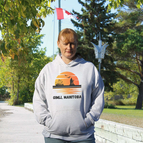 Featuring a sunset backdrop over the charming town of Gimli, Manitoba, with the iconic Viking statue front and center, this hoodie is your stylish ticket to Viking vibes without having to set sail.