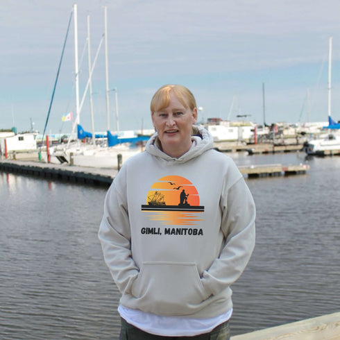Featuring a sunset backdrop over the charming town of Gimli, Manitoba, with the iconic Viking statue front and center, this hoodie is your stylish ticket to Viking vibes without having to set sail.