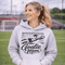 Woman wearing hoodie with goalie mom text and diving goalkeeper graphic