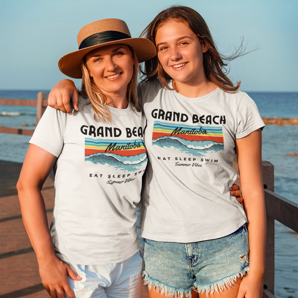 Introducing our Grand Beach Manitoba t-shirt, the perfect addition to your beach wardrobe! Emblazoned with the fun and playful slogan "Eat, Sleep, Swim," this shirt encapsulates the essence of a perfect beach day. Made from soft and breathable fabric, it ensures comfort even on the hottest summer days.