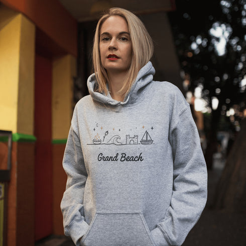 Bring the fun of summer days and campfire nights to your wardrobe with our Grand Beach Doodle hoodie!