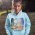 Celebrate the natural beauty and charm of Grand Beach with this cozy and stylish hoodie, featuring a soft watercolor collage of iconic local scenes.