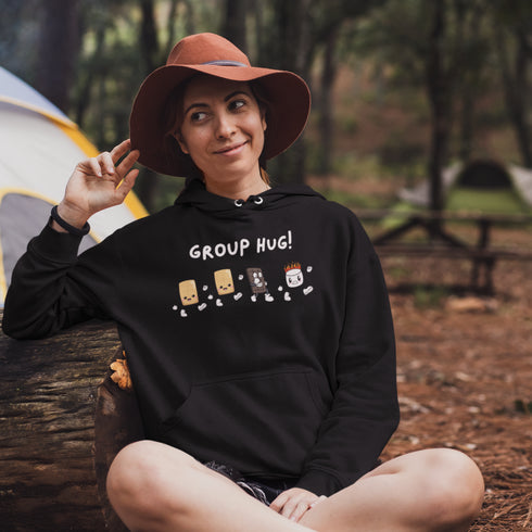 Introducing the ultimate camping companion - the Group Hug Camping Hoodie! Picture this: adorable cartoon s'mores characters chasing a rogue burning marshmallow across your chest, all while proclaiming "Group Hug!" Because who wouldn't want a cuddly trio of snacks on their apparel?