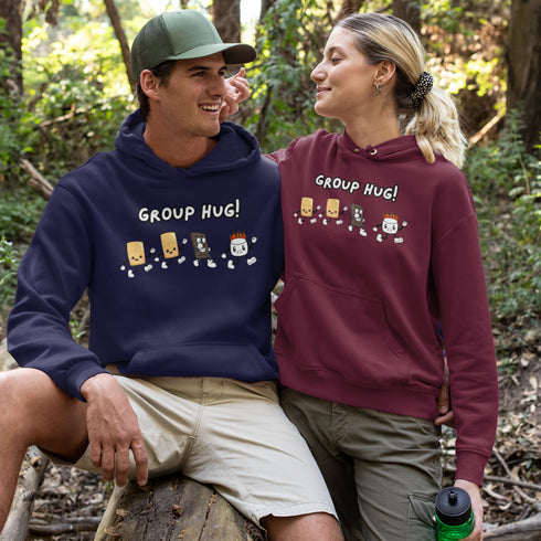 Introducing the ultimate camping companion - the Group Hug Camping Hoodie! Picture this: adorable cartoon s'mores characters chasing a rogue burning marshmallow across your chest, all while proclaiming "Group Hug!" Because who wouldn't want a cuddly trio of snacks on their apparel?