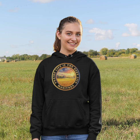 Featuring a breathtaking sunset over a golden wheat field on a farmer's land, this hoodie captures the peaceful essence of Manitoba’s rural charm.