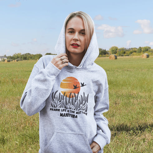 Featuring a stunning design of golden wheat fields stretching across the horizon under a vibrant Canadian sunset, this hoodie captures the peaceful simplicity of prairie life