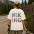 Person wearing a 'Hiking' t-shirt by a Banff, Canada sign.