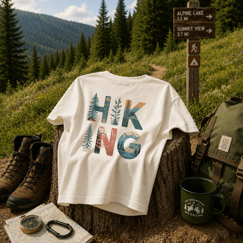 Hiking-themed t-shirt with outdoor gear and nature background