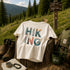 Hiking-themed t-shirt with outdoor gear and nature background