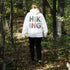 woman wearing hiking hoodie with large nature graphic on back walking in the forest