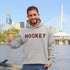 Introducing the Canada Hockey Hoodie, featuring "Hockey" in bold red and black Canadian plaid lettering—because nothing says “I’m Canadian” like plaid and hockey pride.