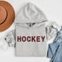 Introducing the Canada Hockey Hoodie, featuring "Hockey" in bold red and black Canadian plaid lettering—because nothing says “I’m Canadian” like plaid and hockey pride.