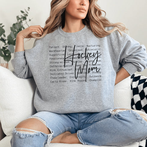 Hockey Mom sweatshirt with handwritten script typography and descriptive text design on a cozy crewneck, perfect for rink moms and hockey season