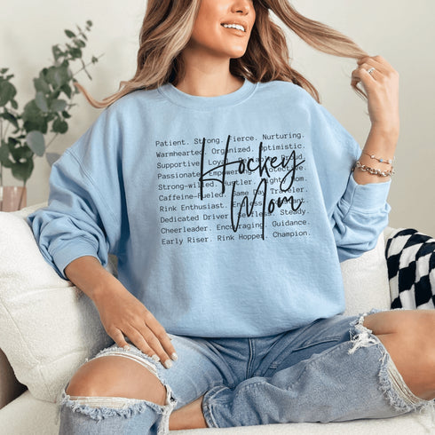 Hockey Mom sweatshirt with handwritten script typography and descriptive text design on a cozy crewneck, perfect for rink moms and hockey season