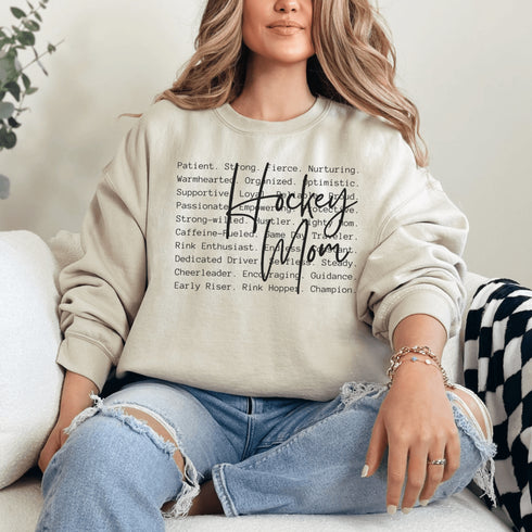 Hockey Mom sweatshirt with handwritten script typography and descriptive text design on a cozy crewneck, perfect for rink moms and hockey season