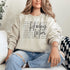 Hockey Mom sweatshirt with handwritten script typography and descriptive text design on a cozy crewneck, perfect for rink moms and hockey season