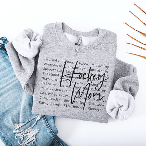 Hockey Mom sweatshirt with handwritten script typography and descriptive text design on a cozy crewneck, perfect for rink moms and hockey season