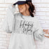 Hockey Mom sweatshirt with handwritten script typography and descriptive text design on a cozy crewneck, perfect for rink moms and hockey season