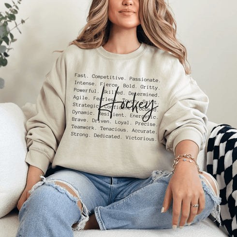 Hockey sweatshirt with bold script lettering and descriptive words design on a cozy crewneck, perfect for hockey players and fans