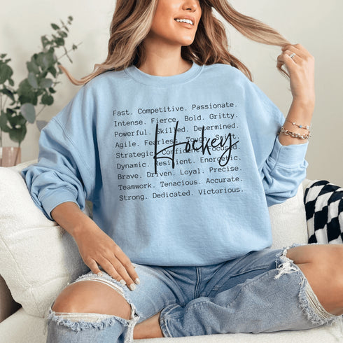 Hockey sweatshirt with bold script lettering and descriptive words design on a cozy crewneck, perfect for hockey players and fans