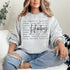 Hockey sweatshirt with bold script lettering and descriptive words design on a cozy crewneck, perfect for hockey players and fans