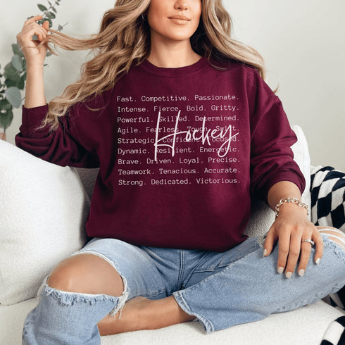 Hockey sweatshirt with bold script lettering and descriptive words design on a cozy crewneck, perfect for hockey players and fans