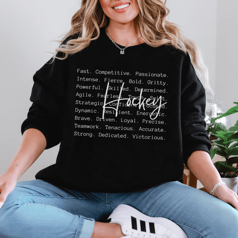Hockey sweatshirt with bold script lettering and descriptive words design on a cozy crewneck, perfect for hockey players and fans