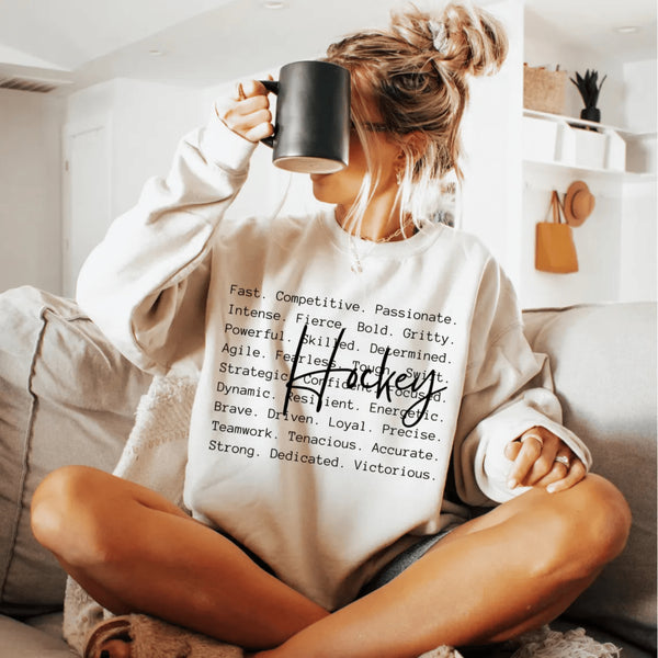 Hockey sweatshirt with bold script lettering and descriptive words design on a cozy crewneck, perfect for hockey players and fans