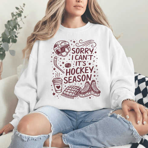 Funny hockey season sweatshirt with “Sorry I Can’t It’s Hockey Season” design featuring skates, stick, puck, and coffee cup – cozy rink apparel for hockey moms and fans
