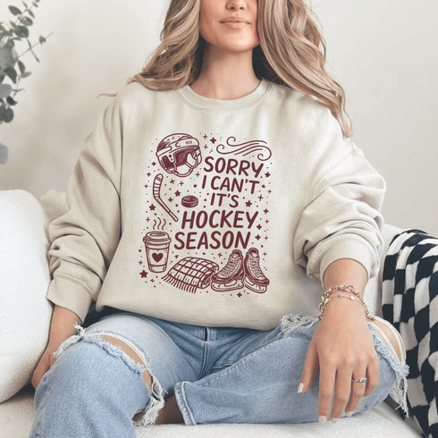Funny hockey season sweatshirt with “Sorry I Can’t It’s Hockey Season” design featuring skates, stick, puck, and coffee cup – cozy rink apparel for hockey moms and fans