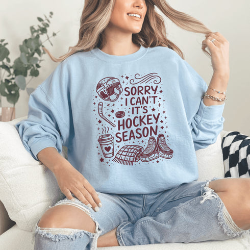 Funny hockey season sweatshirt with “Sorry I Can’t It’s Hockey Season” design featuring skates, stick, puck, and coffee cup – cozy rink apparel for hockey moms and fans
