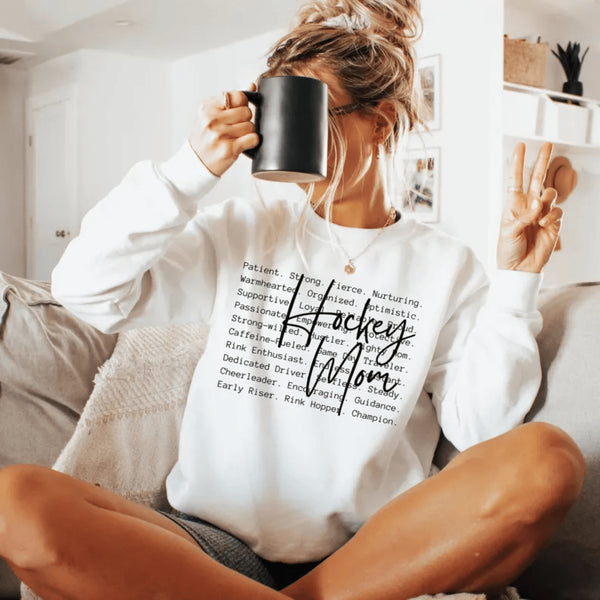 Hockey Mom sweatshirt with handwritten script typography and descriptive text design on a cozy crewneck, perfect for rink moms and hockey season