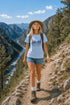 Woman hiking on a mountain trail with scenic view
