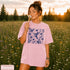 Vintage-inspired hummingbird and butterfly wildflower graphic printed on a Blossom pink Comfort Colors t-shirt.