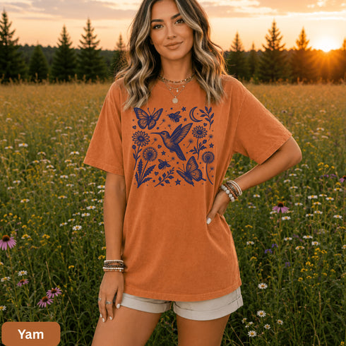 Vintage-inspired hummingbird and butterfly wildflower graphic printed on a Yam colored Comfort Colors t-shirt.