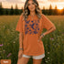Vintage-inspired hummingbird and butterfly wildflower graphic printed on a Yam colored Comfort Colors t-shirt.