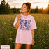 Vintage-inspired hummingbird and butterfly wildflower graphic printed on a Blossom pink Comfort Colors t-shirt.