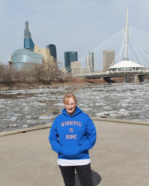 Introducing the ultimate statement of pride and comfort: the "Winnipeg Is Home" Hoodie. Designed for those who hold Winnipeg close to their heart, this hoodie is more than just a piece of clothing—it's a declaration of love for the heart of the prairies.