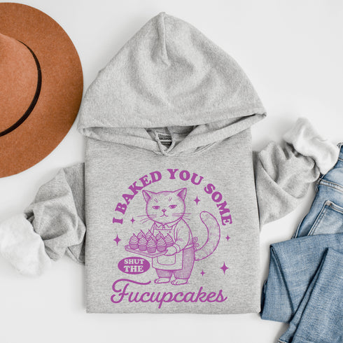 Featuring a sarcastic-looking cat holding a tray of cupcakes, this design pairs sugary sweetness with a healthy dose of sass.