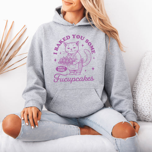 Featuring a sarcastic-looking cat holding a tray of cupcakes, this design pairs sugary sweetness with a healthy dose of sass.